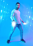 Hologram, metaverse and portrait of a man in a studio with a cyber, digital or scifi overlay for gaming. Virtual reality, futuristic and male gamer with a 3d fantasy experience by a blue background.