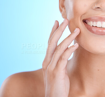 Buy stock photo Hands, face and touching skin with a model woman in studio on a blue background for beauty or skincare. Hand, touch and facial with a young female indoor to promote an antiaging skin product