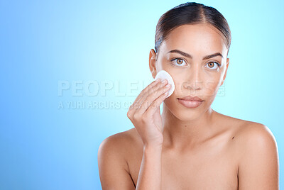 Buy stock photo Portrait, cotton pad and black woman isolated on blue background for face or facial cleaning product promotion. Young model or person for beauty glow, cosmetics wipe and makeup in studio mockup space