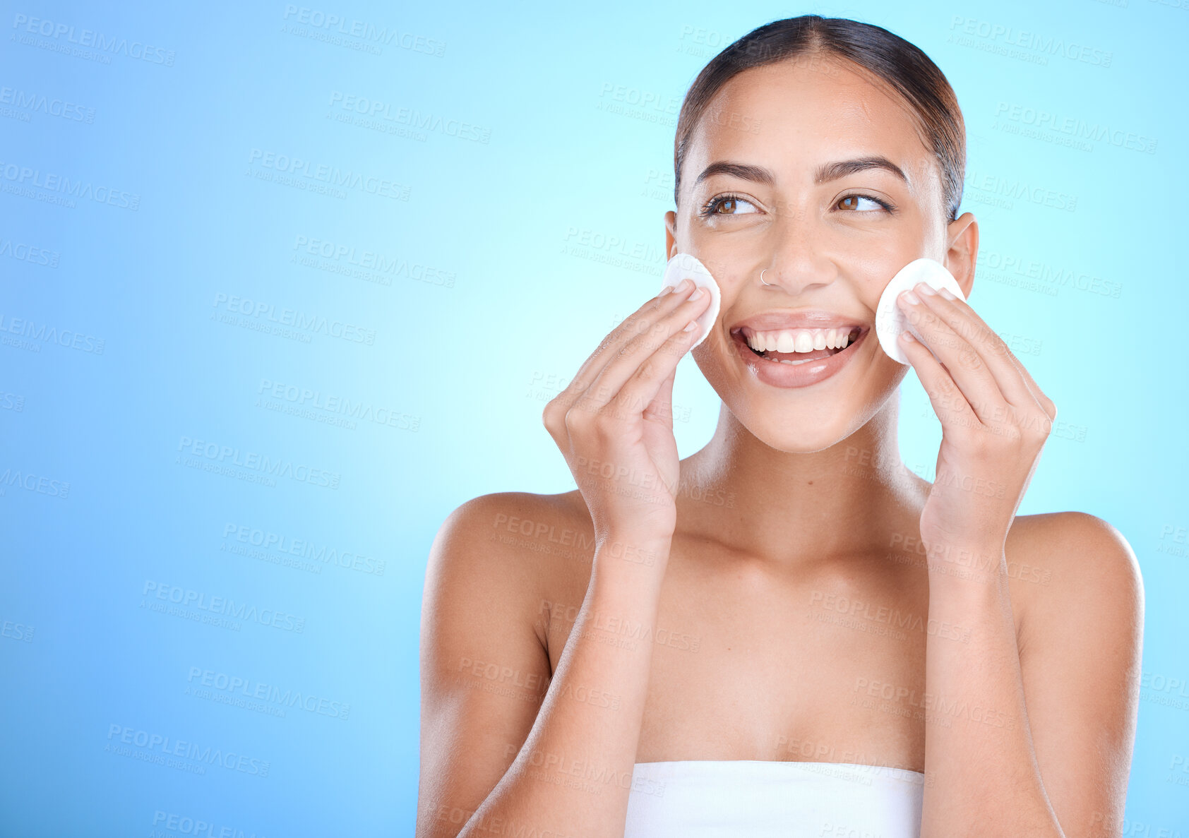 Buy stock photo Skincare, cotton and woman in studio for face, beauty and cosmetics on blue background. Facial, pad and girl wellness model relax with luxury, product and cleaning, makeup and removal while isolated
