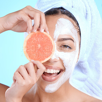 Buy stock photo Portrait, skincare and woman with grapefruit mask in studio for beauty, hair and cosmetics on blue background, Face, facial and girl model relax with fruit, luxury and product, wellness or isolated