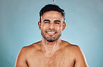 Portrait, wet and man with water, cleaning and hygiene with guy on blue studio background. Face, male and gentleman with liquid, aqua or washing for skincare, morning routine or grooming on backdrop 