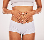 Gut health, hands in heart and stomach of woman on white background for digestion, diet and weight loss. Fitness, body wellness and abdomen of girl for healthy lifestyle, tummy tuck and liposuction
