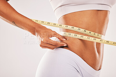 Measuring tape, stomach and woman in studio for wellness, weight loss and  tummy tuck on grey backgr Stock Photo by YuriArcursPeopleimages