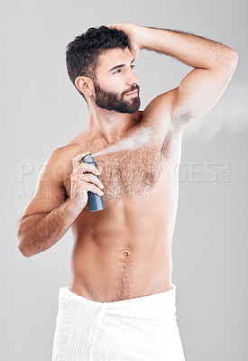 Buy stock photo Man, armpit and spray deodorant in studio for hygiene, fresh scent or perfume. Male model spraying underarm for body odor, smell and cleaning cosmetics, shower product and skincare mist on background