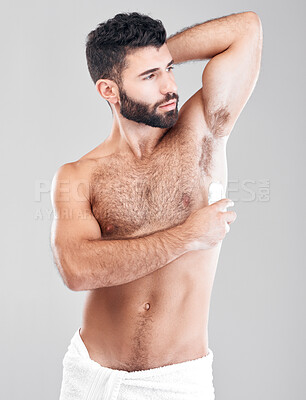 Buy stock photo Deodorant, roll and man grooming in studio for hygiene, fresh scent or underarm perfume. Male model, armpit and cosmetics for sweat control, body odor and cleaning product for skincare on background