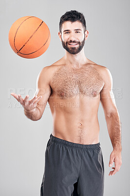 Buy stock photo Fitness, portrait of man throwing basketball in air and smile, topless and isolated on grey background. Exercise, motivation and ball sports coach or personal trainer with workout mindset in studio.