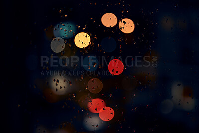 Buy stock photo Bokeh, night and lights on a window with water drops, liquid or moisture against a dark abstract background. Blurred light, colorful and rain drop or splash on glass for city view during rainy season