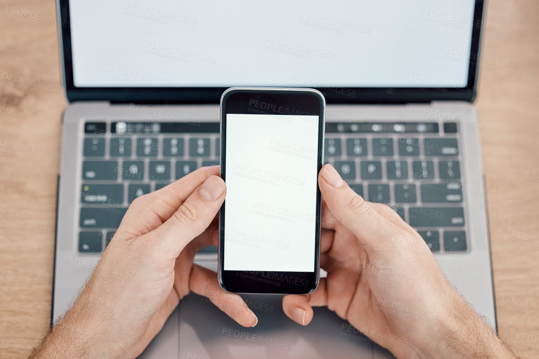 Buy stock photo Hands, phone and laptop on mockup screen for networking, social media or mobile app at office desk. Hand of person with display on smartphone for online advertising, branding logo or marketing