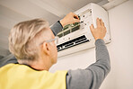 Maintenance, installation and back of a man with air conditioner for service and ac repair. Building, technician and a handyman fitting an appliance on a wall of a home for home improvement and heat