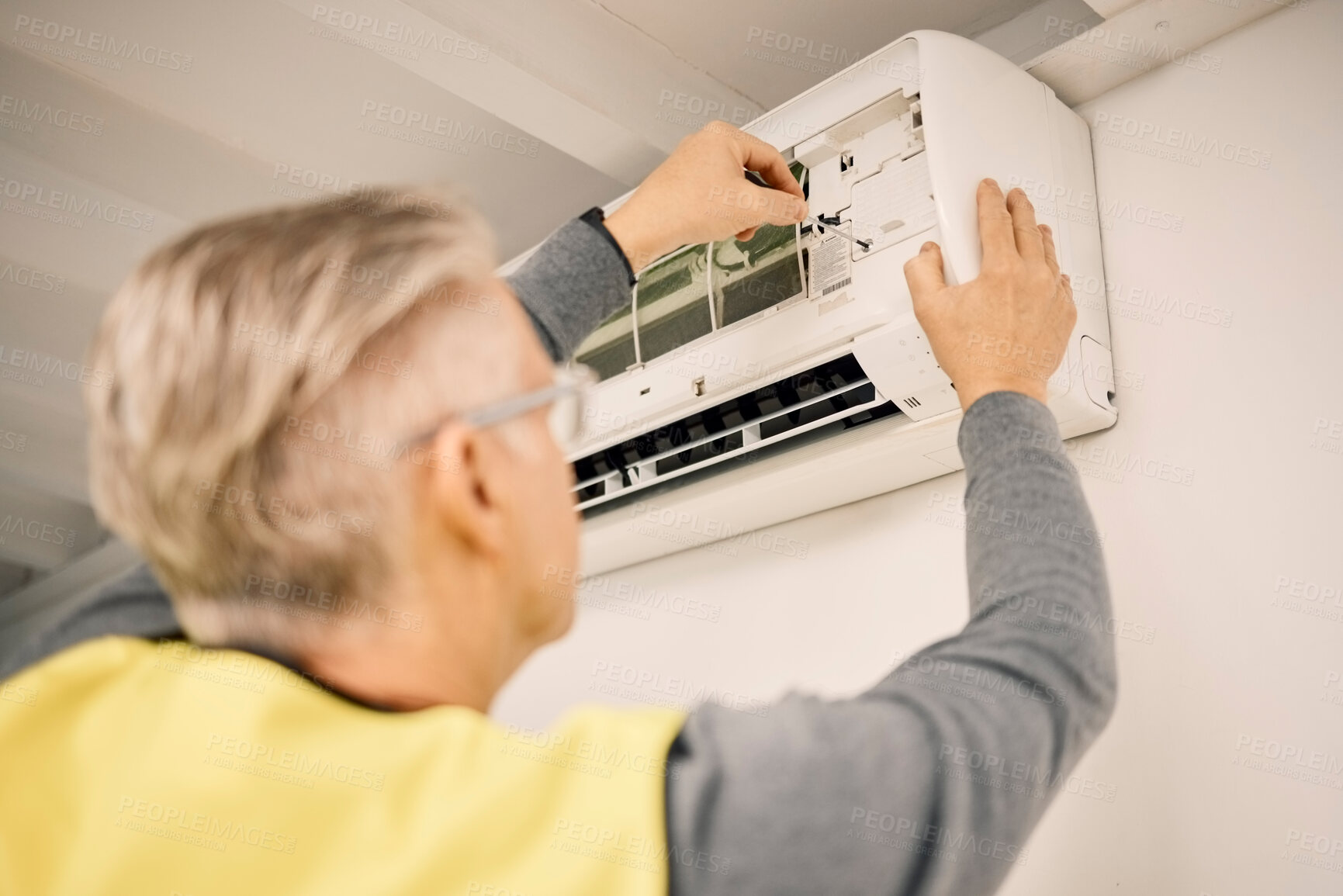 Buy stock photo Maintenance, installation and back of a man with air conditioner for service and ac repair. Building, technician and a handyman fitting an appliance on a wall of a home for home improvement and heat