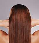 Hair care, keratin and back of a woman for a salon isolated on a grey studio background. Beauty, strong and girl showing growth, shine and clean straight hairstyle from shampoo on a backdrop