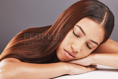 Buy stock photo Hair care, sleeping and woman with studio background, tired and elegant style with confidence, rest and relax. Cosmetics, female and girl on grey backdrop, dreaming about keratin treatment and calm