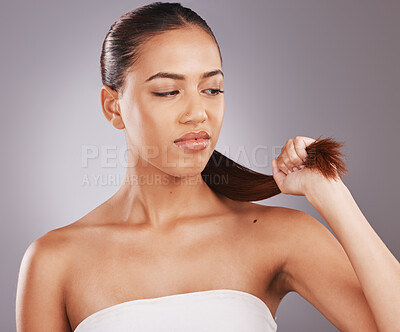 Buy stock photo Hair split ends, beauty salon and dye damage of a black woman with a problem feeling annoyed. Shampoo fail, cosmetic and dry haircut of a model frustrated with isolated gray background in a studio
