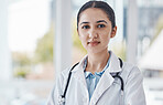 Leader, female and portrait of a doctor in the hospital after a healthcare consultation. Confident, young and proud professional woman medical worker standing in a medicare clinic after a checkup.