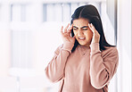 Headache, stress or burnout with an indian woman on a blurred background suffering from pain or anxiety. Compliance, mental health or mistake and a frustrated young female struggling with a migraine