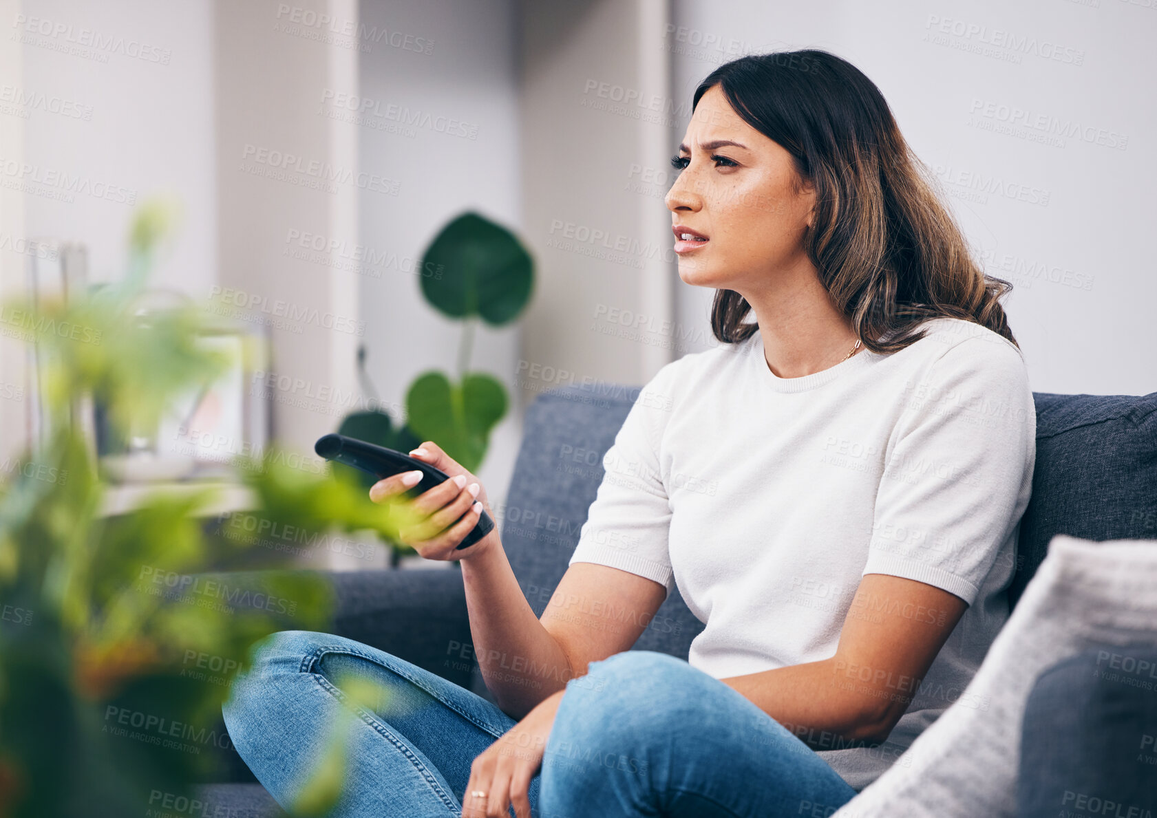 Buy stock photo Woman confused, watching tv and remote control, relax at home and squint with vision problem and streaming movie. Thinking, entertainment and confusing television show with young person in lounge