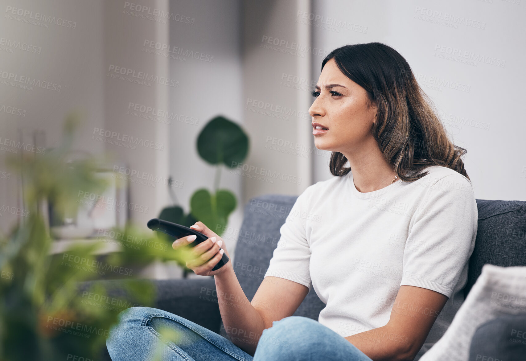 Buy stock photo Woman confused watching tv, streaming with remote control and relax at home, thinking or vision problem with squint. Entertainment with leisure in living room and confusing television show or film 