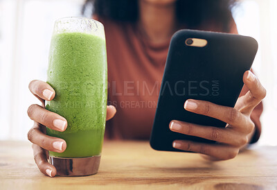 Buy stock photo Hands, smoothie and phone with a black woman in the kitchen of her home for health, weight loss or nutrition. Mobile, glass and wellness with a female posting a status update on social media