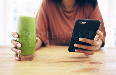 Buy stock photo Hands, glass and phone with a black woman in the kitchen of her home for health, weight loss or nutrition. Mobile, smoothie and wellness with a female posting a status update on social media
