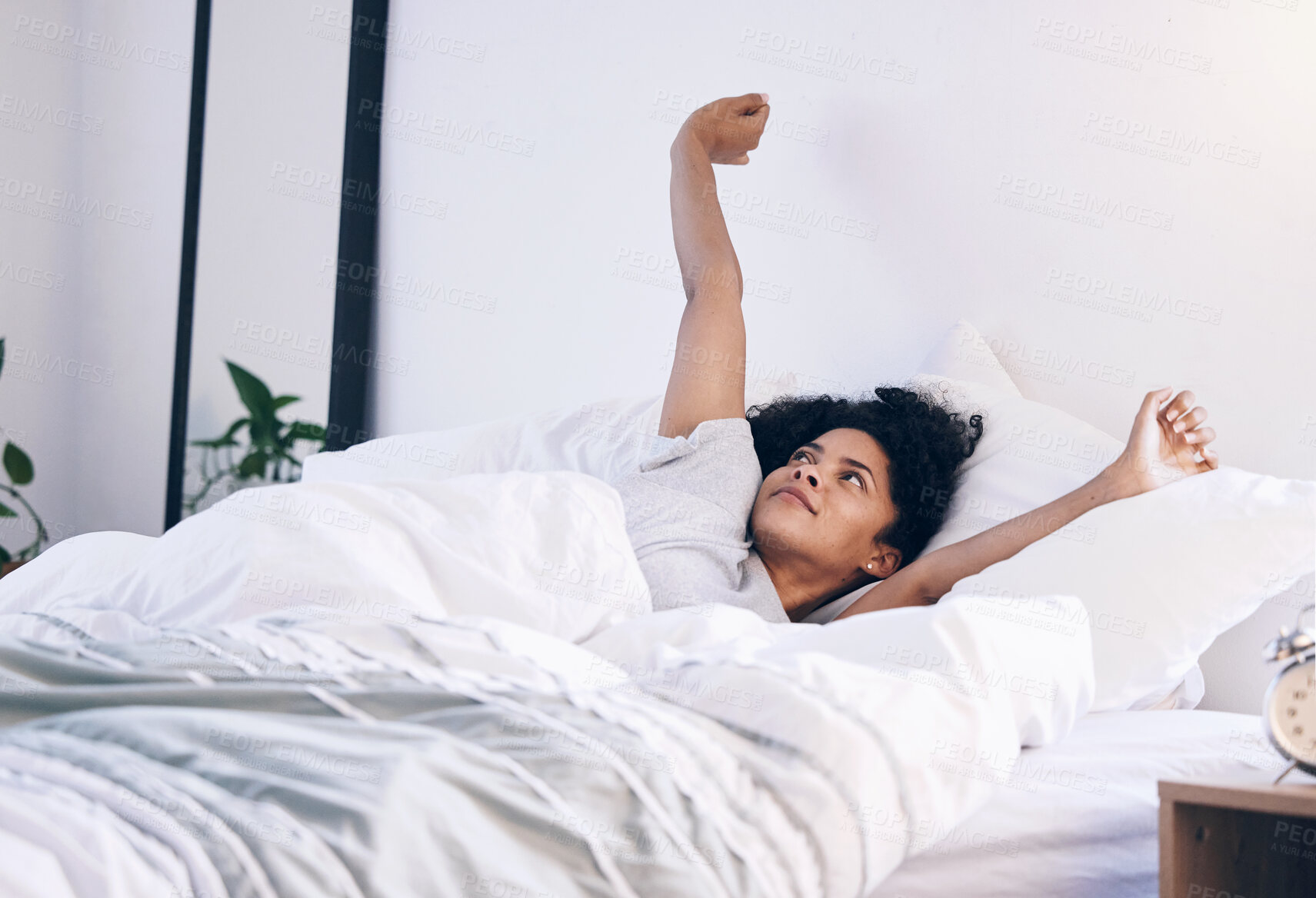 Buy stock photo Morning stretch, wake up and black woman in bed with peace feeling relax in a bedroom. Home, day start and calm young person in a house stretching arms on a lazy weekend ready for sleep or nap