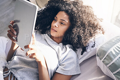 Buy stock photo Tablet, black woman and relax in bed in bedroom for social media, texting or internet browsing in the morning. Technology, home and female with digital touchscreen for web scrolling after waking up.