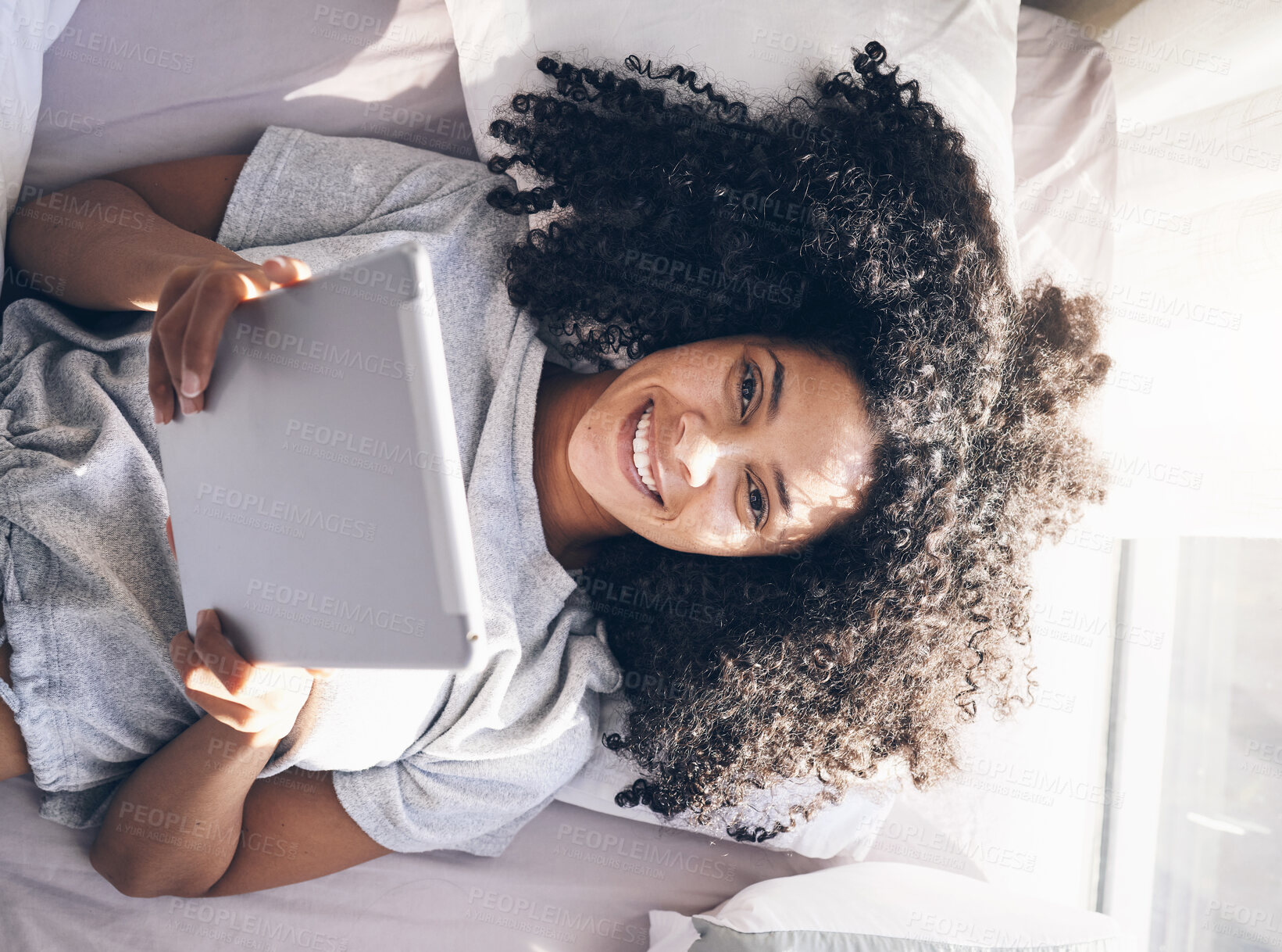 Buy stock photo Tablet, black woman and top view in bed in bedroom for social media, texting or internet browsing in the morning. Portrait, relax and female on digital touchscreen for web scrolling or networking.