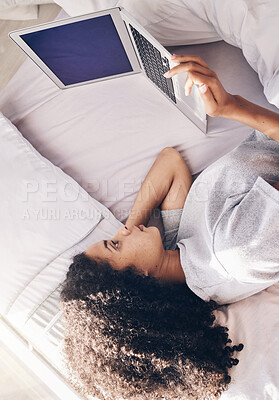 Buy stock photo Lazy, sad and woman lying down with a laptop watching or streaming movie, website or app in a home, house or apartment. Rest, break and young black female using in internet subscription to relax 