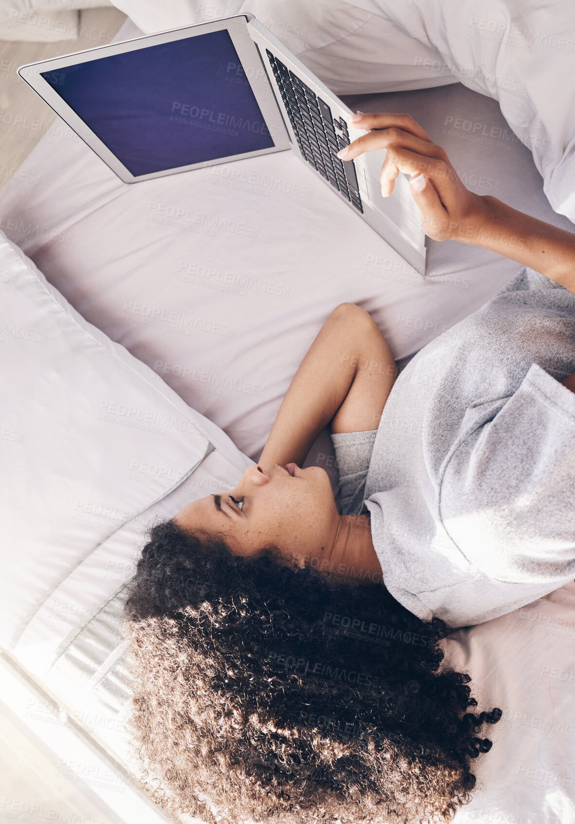 Buy stock photo Lazy, sad and woman lying down with a laptop watching or streaming movie, website or app in a home, house or apartment. Rest, break and young black female using in internet subscription to relax 