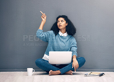 Buy stock photo Laptop, thinking and pointing with black woman on floor with mockup for social media, news and presentation. Offer, online shopping and technology with girl for communication, internet or advertising