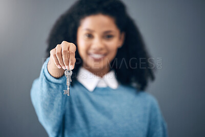 Buy stock photo Black woman, hands and key for real estate, new home or property against a gray studio background. Hand of happy African American female holding keys for rent, building loan or investment on mockup