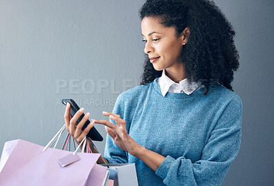 Buy stock photo Shopping bag, phone or black woman for fashion sale, discount or luxury brand store. Mockup, internet or girl with smile on smartphone for social media, promo code or online retail website app news