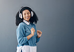 Dance, music and black woman in studio with freedom, streaming or good mood on grey background. Radio, podcast and girl relax while dancing to audio, online and playlist on advertising isolated space