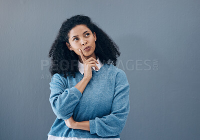 Buy stock photo Thinking, ponder and woman in a studio contemplating a question or plan in her head. Wondering, pensive and female model from Mexico brainstorming while isolated by gray background with mockup space.