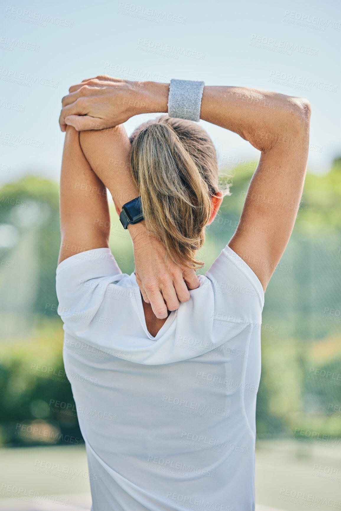 Buy stock photo Tennis, back and stretching arm with a sports woman on a court for a warm up before a competitive game. Sport, fitness or training with a female athlete getting ready for a practice match from behind