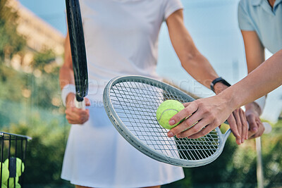 Buy stock photo Tennis training, hands and ball with women and athlete on outdoor turf, instructor or coach, fitness motivation and help. Exercise, sports lesson and workout together, teaching and learn on court
