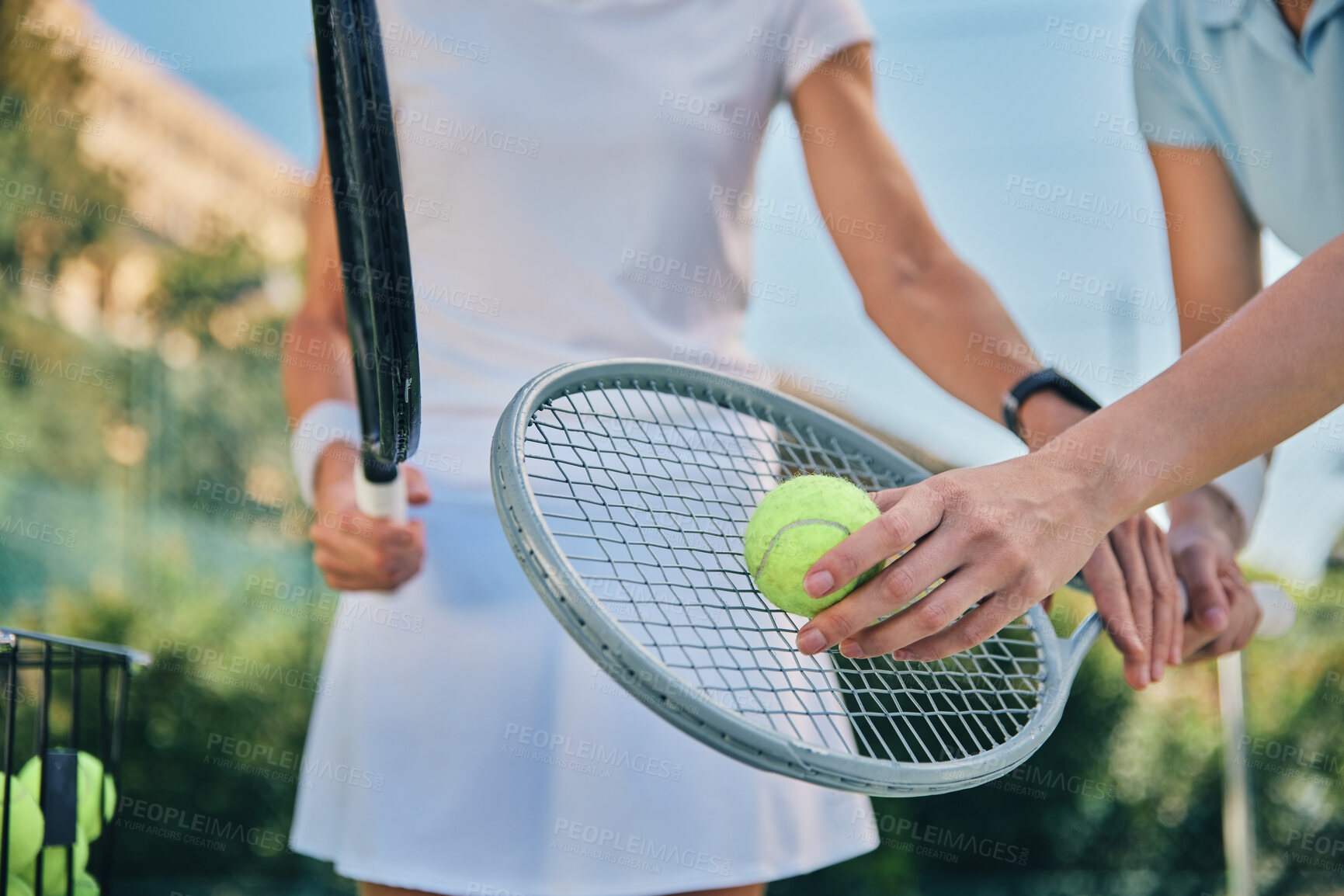 Buy stock photo Tennis training, hands and ball with women and athlete on outdoor turf, instructor or coach, fitness motivation and help. Exercise, sports lesson and workout together, teaching and learn on court