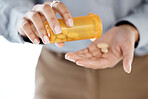 Closeup, hands and pills for depression, stress and medication for cure, diagnosis and treatment. Zoom, female patient and lady with orange container, medicine or prescription for illness or sickness