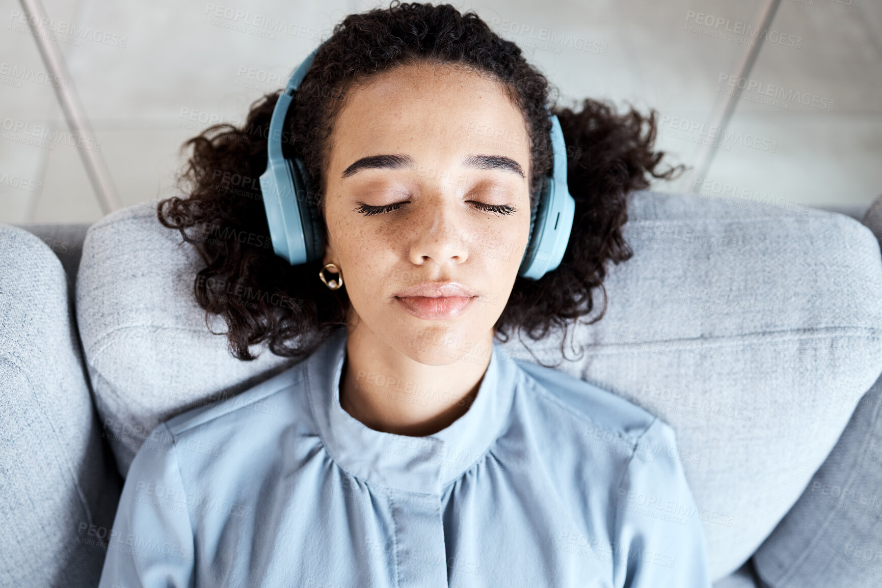 Buy stock photo Woman, face and headphones for listening to music for calm, peace and mindfulness on home couch. Young person on living room sofa listen to podcast, audio or motivation to relax or meditation above