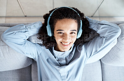 Buy stock photo Top view, portrait and woman on sofa, headphones and relax for break, peace and smile with joy. Female, lady and headset music, streaming and listen to podcast for happiness, cheerful and peaceful