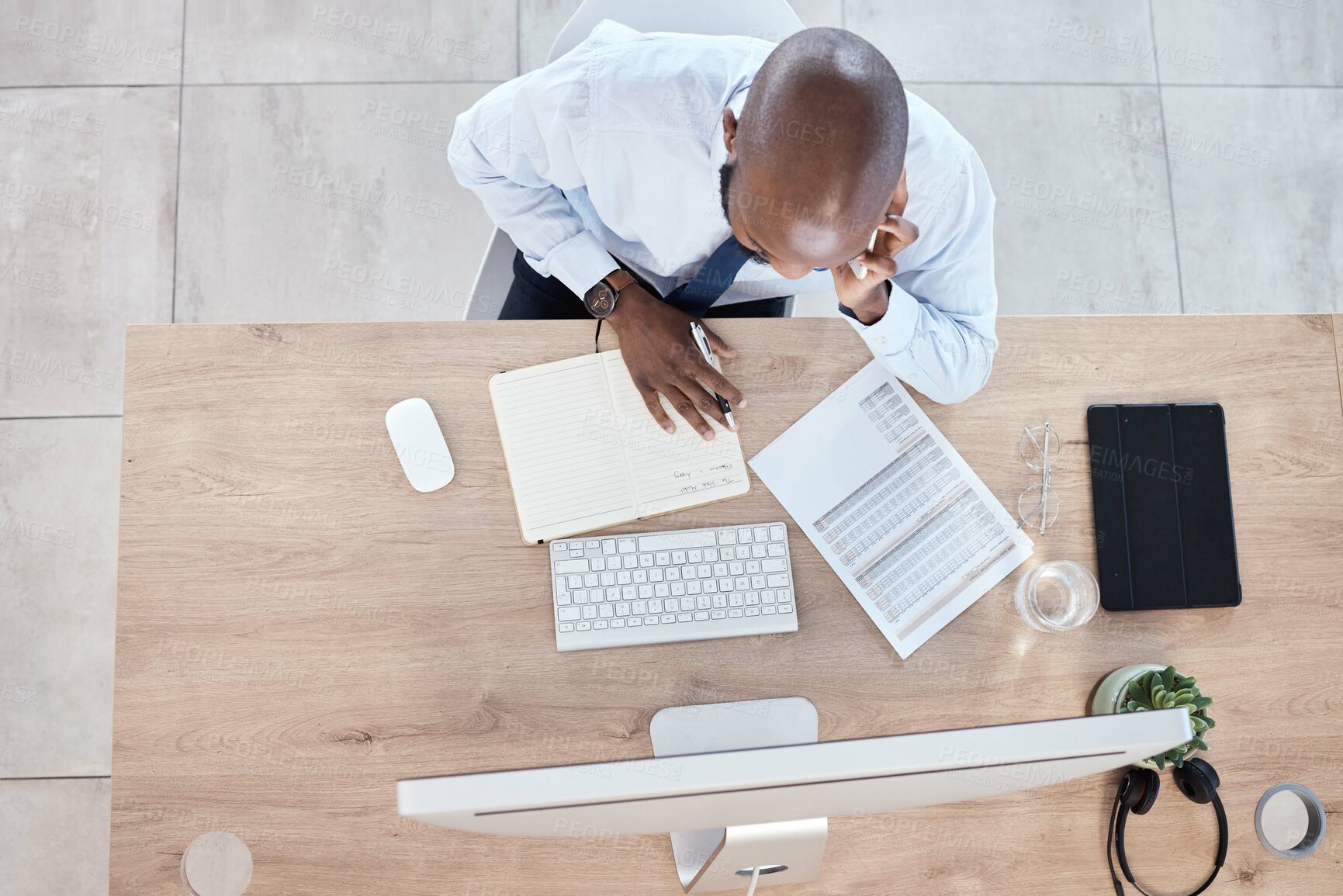 Buy stock photo Documents, notes and businessman on phone call planning a schedule or growth strategy for a startup in an office. Overhead, employee or black man working in discussion on mobile conversation