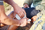 Sport bandage, first aid and medical support for knee pain of elderly man hiking in a mountain. Exercise, fitness and paramedic in nature with senior athlete hurt from sports accident outdoor