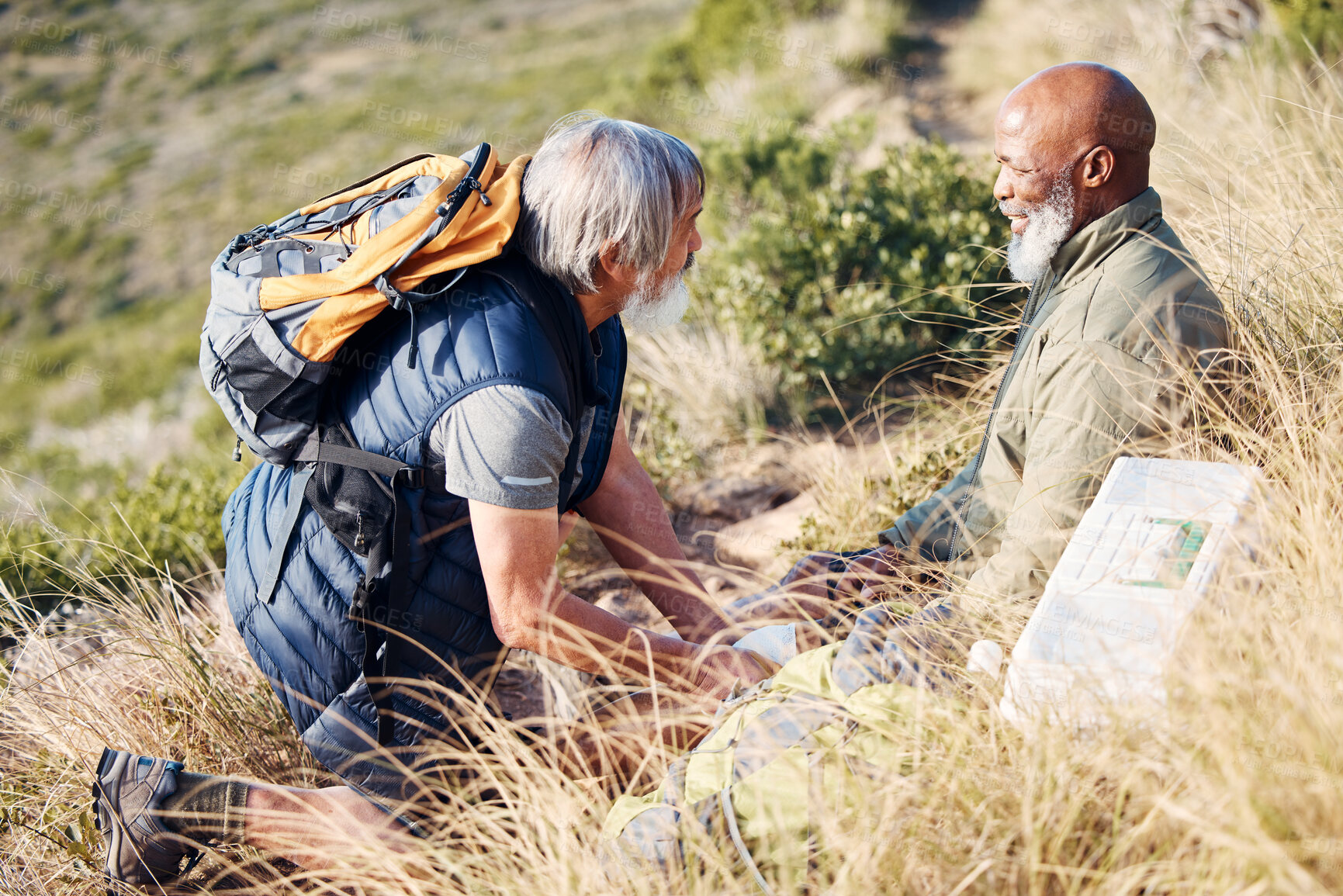 Buy stock photo First aid, knee pain and hiking with senior friends in nature for trekking, adventure and fitness. Help, bandage and medical with old men and injury on trail for backpacking, discovery and emergency