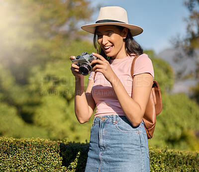 Buy stock photo Photography, tourism and woman with a camera in nature for travel memory in Sweden. Summer, tourist and photographer looking at photos while traveling on a vacation in a park or botanical garden
