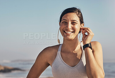 Buy stock photo Woman, fitness and portrait while listening to music at beach for exercise, training and workout. Happy model person face in nature with earphones for podcast, audio and motivation outdoor in nature