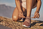 Hands, hiking and tie shoes in nature to start running, workout or training. Sports, wellness and female or woman tying sneaker laces or footwear to get ready for exercising, cardio or hike outdoors.