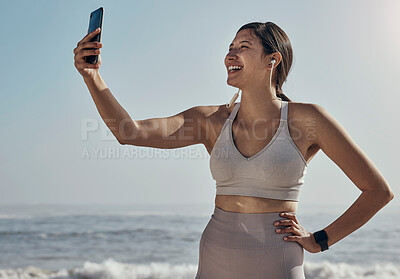 Fitness, selfie and woman at the beach for yoga, training and workout on blue sky background. Social media, live streaming and exercise influencer female recording for blog, post or profile picture