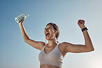 Fitness winner, workout and woman with drinking bottle for achievement outdoor. Excited, smile and athlete with blue sky feeling freedom from motivation and happiness with exercise target goal