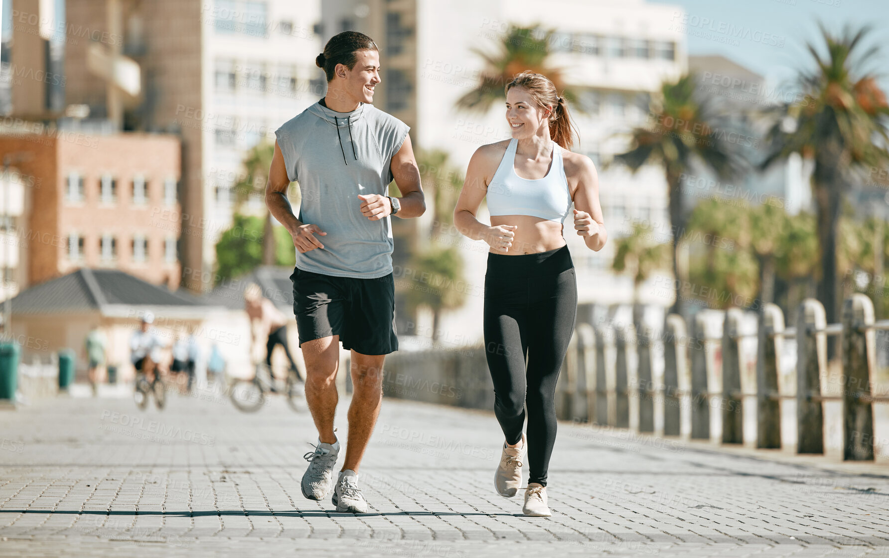 Buy stock photo Couple, running and training together in the city for exercise, workout or cardio routine in Cape Town. Happy man and woman runner in fitness, walk or jog for healthy wellness or exercising outside
