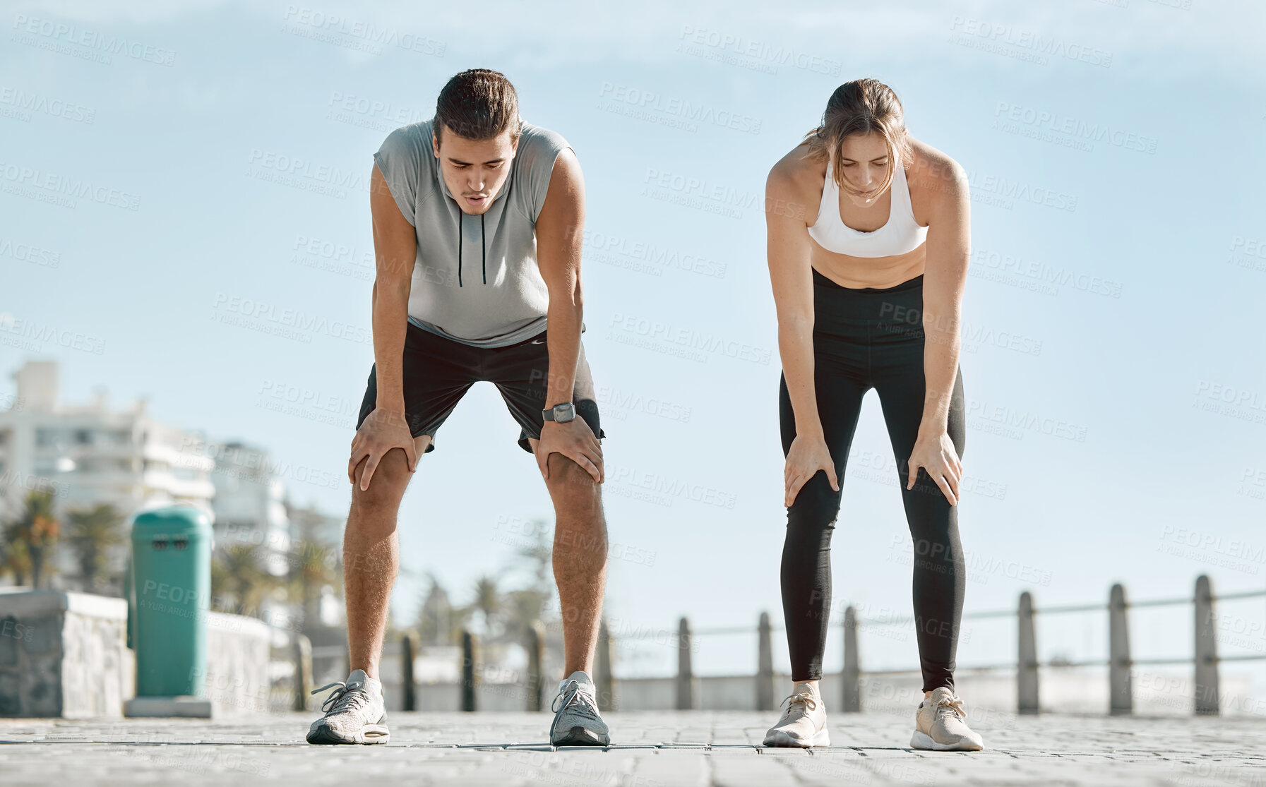 Buy stock photo Fitness, exercise and tired couple with blue sky to rest for health and wellness outdoor. Man and woman for city workout, cardio performance and healthy lifestyle for body fatigue, breathe and energy